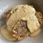 Bowl of banana bread with warm homemade custard poured on top